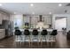 Open concept kitchen with a large island, modern appliances, and ample counter space at 745 Orange Oak Ln, Apex, NC 27523