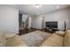 Spacious living room has hardwood floors, a comfortable couch, and is connected to a staircase at 745 Orange Oak Ln, Apex, NC 27523