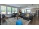 Bright and airy living room with a large sectional sofa, area rug, and plenty of natural light at 745 Orange Oak Ln, Apex, NC 27523