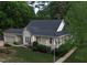 Aerial view of the home showing the roof, well-manicured lawn, mature trees and covered front porch at 7716 Micklewaithe Ct, Wake Forest, NC 27587