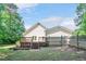 Spacious backyard with a deck, a fenced in area, and lush greenery at 7716 Micklewaithe Ct, Wake Forest, NC 27587