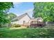 Expansive backyard featuring a wooden deck, well-maintained lawn, and mature trees at 7716 Micklewaithe Ct, Wake Forest, NC 27587