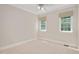 Cozy bedroom featuring two windows allowing for natural light and a ceiling fan at 7716 Micklewaithe Ct, Wake Forest, NC 27587