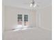 Spacious bedroom bathed in natural light with glass paneled french doors leading to a deck at 7716 Micklewaithe Ct, Wake Forest, NC 27587