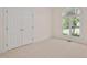 Bright bedroom featuring neutral carpet and large window letting in an abundance of natural light at 7716 Micklewaithe Ct, Wake Forest, NC 27587