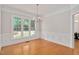 Dining room featuring wainscoting detail, large window and decorative chandelier at 7716 Micklewaithe Ct, Wake Forest, NC 27587
