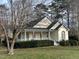 Traditional-style home with a welcoming front porch and mature trees in a well-kept yard at 7716 Micklewaithe Ct, Wake Forest, NC 27587