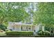 Charming home with a manicured lawn and a welcoming front porch with decorative columns at 7716 Micklewaithe Ct, Wake Forest, NC 27587