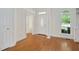 Bright foyer with hardwood floors, white trim, and front door at 7716 Micklewaithe Ct, Wake Forest, NC 27587