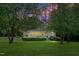 Charming home featuring a well-maintained lawn and inviting front porch at dusk at 7716 Micklewaithe Ct, Wake Forest, NC 27587