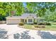 Charming single story home with a well-maintained lawn, mature trees, and a two-car garage at 7716 Micklewaithe Ct, Wake Forest, NC 27587