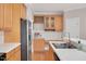 The kitchen features stainless appliances, light wood cabinetry, wine storage, and white subway tile backsplash at 7716 Micklewaithe Ct, Wake Forest, NC 27587