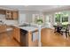 Spacious kitchen featuring stainless appliances, eat-in area, and access to the outdoor patio and garden at 7716 Micklewaithe Ct, Wake Forest, NC 27587