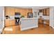 Charming kitchen featuring stainless steel appliances, wood cabinets, and breakfast bar overlooking the adjacent rooms at 7716 Micklewaithe Ct, Wake Forest, NC 27587