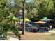 Colorful playground featuring varied play equipment, canopies and shaded seating areas at 7716 Micklewaithe Ct, Wake Forest, NC 27587