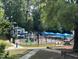 Community playground with water features, slides and sunshades in a lush park setting at 7716 Micklewaithe Ct, Wake Forest, NC 27587