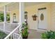 Welcoming front porch with classic white columns, white railing, and front door with oval window at 7716 Micklewaithe Ct, Wake Forest, NC 27587