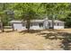 View of backyard showcasing the rear of the house with brick and vertical siding at 7824 Knightdale Blvd, Knightdale, NC 27545