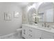 Stylish bathroom featuring a dual-sink vanity, marble floor, and modern lighting at 7824 Knightdale Blvd, Knightdale, NC 27545