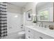 Bright bathroom featuring white vanity, shower and tub combo, and ample natural light at 7824 Knightdale Blvd, Knightdale, NC 27545