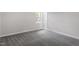 Clean bedroom featuring neutral walls, carpeting, and a window for natural light at 7824 Knightdale Blvd, Knightdale, NC 27545