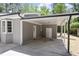 Attached carport with storage space, concrete floor, and gray vertical siding at 7824 Knightdale Blvd, Knightdale, NC 27545