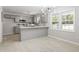 Modern kitchen features gray cabinets, stainless appliances, and a breakfast bar with bright natural light at 7824 Knightdale Blvd, Knightdale, NC 27545