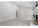 Bright living room featuring a cozy fireplace, arched window, and sliding glass door at 7824 Knightdale Blvd, Knightdale, NC 27545