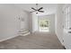 Spacious living room with ceiling fan, back door, and ample natural light at 7824 Knightdale Blvd, Knightdale, NC 27545