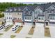 Aerial view of the townhomes with front garages and driveways in a well-planned community at 805 Grafton Peak Lane Ln, Apex, NC 27523