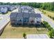 Beautiful backyard view of multiple townhomes with manicured lawns and wooded scenery at 805 Grafton Peak Lane Ln, Apex, NC 27523
