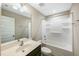Clean bathroom with a shower-tub combo, vanity and a large mirror at 805 Grafton Peak Lane Ln, Apex, NC 27523