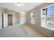 Airy bedroom offering natural light and closet space; neutral carpet and walls create a calming atmosphere at 805 Grafton Peak Lane Ln, Apex, NC 27523