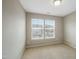 Cozy bedroom featuring neutral walls, plush carpet, and natural light from double windows at 805 Grafton Peak Lane Ln, Apex, NC 27523