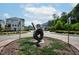 The community includes landscaped areas like the roundabout with decorative greenery and sculpture at 805 Grafton Peak Lane Ln, Apex, NC 27523