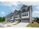 Modern townhomes feature multi-toned exteriors and attached garages with driveways at 805 Grafton Peak Lane Ln, Apex, NC 27523