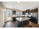 Gourmet kitchen with large island, stainless appliances, and granite countertops at 805 Grafton Peak Lane Ln, Apex, NC 27523