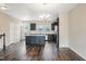 Open concept living area adjacent to the kitchen with hardwood floors at 805 Grafton Peak Lane Ln, Apex, NC 27523