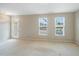 Bright living room featuring neutral walls, plush carpeting, and outdoor access at 805 Grafton Peak Lane Ln, Apex, NC 27523