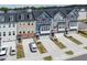 Charming townhomes featuring a front-entry garage and well-manicured landscaping on a sunny day at 805 Grafton Peak Lane Ln, Apex, NC 27523