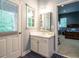 Bathroom with access to the outside and view to a bedroom, featuring a small window and blue flooring at 816 Roanoke Dr, Cary, NC 27513
