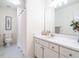 Bright bathroom with tile flooring, shower with white curtain, large mirror, and double vanity at 816 Roanoke Dr, Cary, NC 27513
