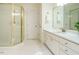 Well-lit bathroom featuring a glass-enclosed shower, white vanity, and hexagon tile flooring at 816 Roanoke Dr, Cary, NC 27513
