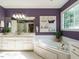 Bathroom with white hexagon tiles, a jacuzzi bathtub, and double vanity at 816 Roanoke Dr, Cary, NC 27513