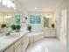 Serene bathroom with a soaking tub, dual vanities, and ample natural light from a large window at 816 Roanoke Dr, Cary, NC 27513