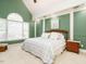 Spacious bedroom featuring neutral carpet, green walls, windows offering natural light, and a wooden bed frame at 816 Roanoke Dr, Cary, NC 27513