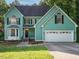 Inviting two-story home with well-manicured lawn and two-car garage at 816 Roanoke Dr, Cary, NC 27513