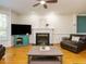 Cozy living room featuring a fireplace, ceiling fan, and hardwood floors at 816 Roanoke Dr, Cary, NC 27513
