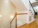 Staircase featuring wood railings, white spindles, and hardwood floors at 816 Roanoke Dr, Cary, NC 27513