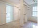 Functional walk-in closet with built-in shelving, hanging rods, and easy access to the en-suite bathroom at 816 Roanoke Dr, Cary, NC 27513